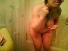 Mature brunette milf takes a shower and rubs her body