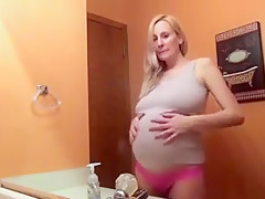 Pregnant blonde beauty in the bathroom